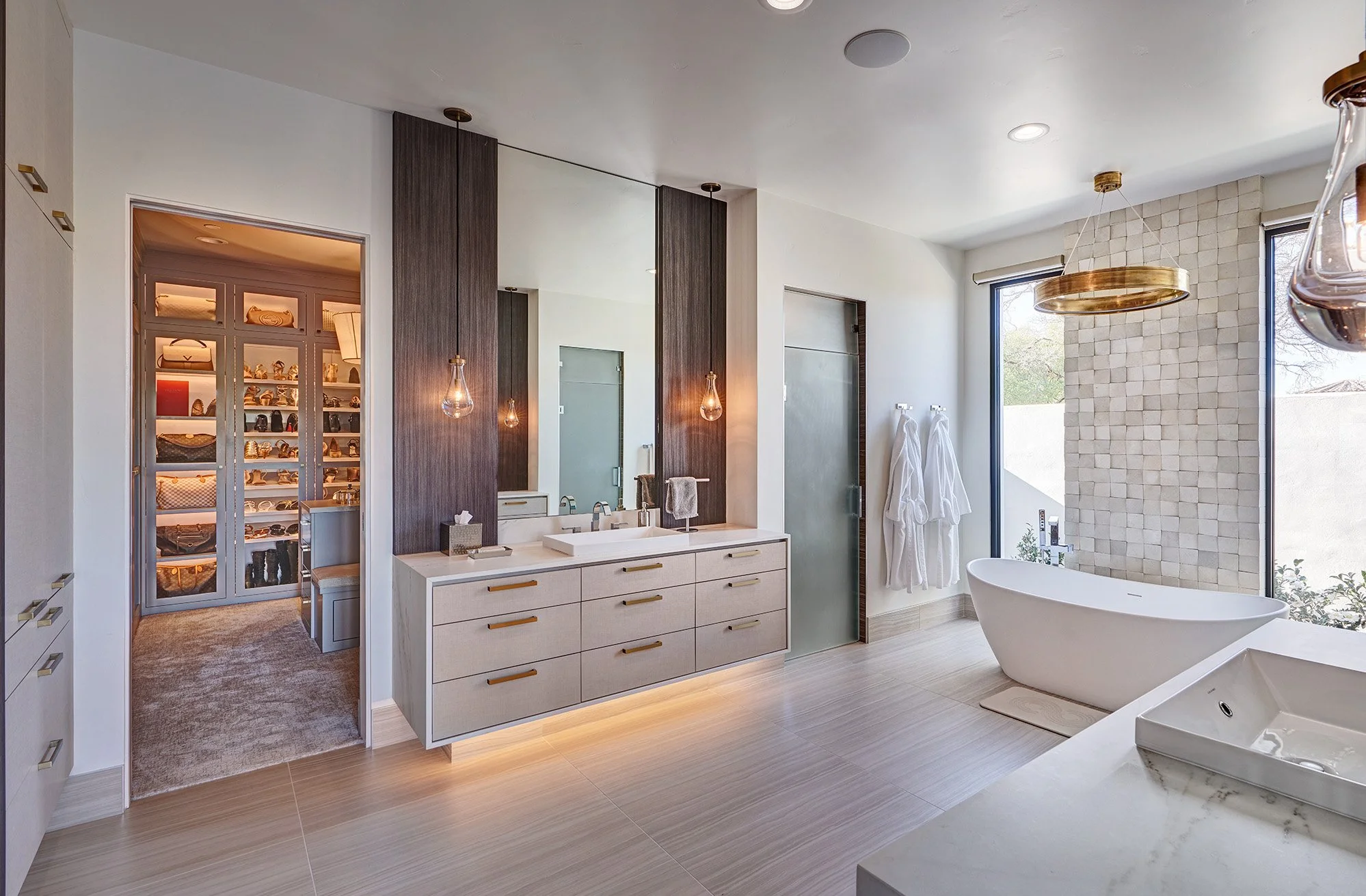 Modern new construction home, European cabinetry, floating vanity with underlighting, freestanding tub, primary bathroom
