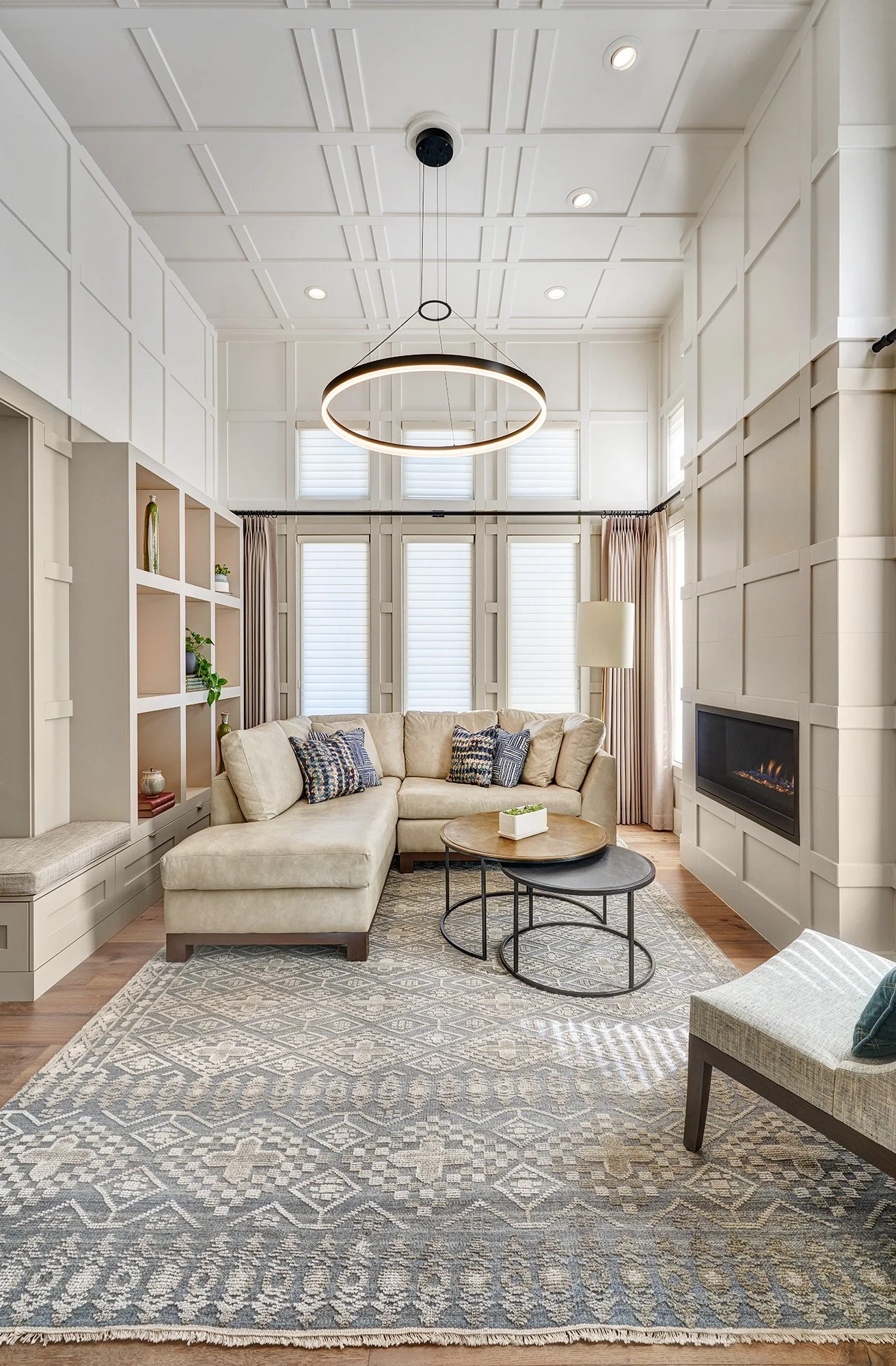 Millwork wrapped living room, linear fireplace, bookshelves, two toned