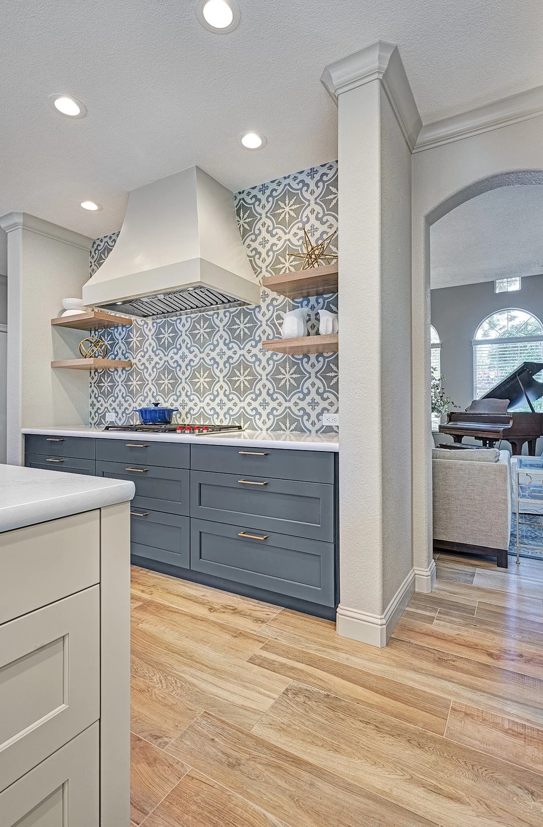 Modern Spanish colonial style kitchen remodel, blue, white + wood cabinetry, patterned tile splash