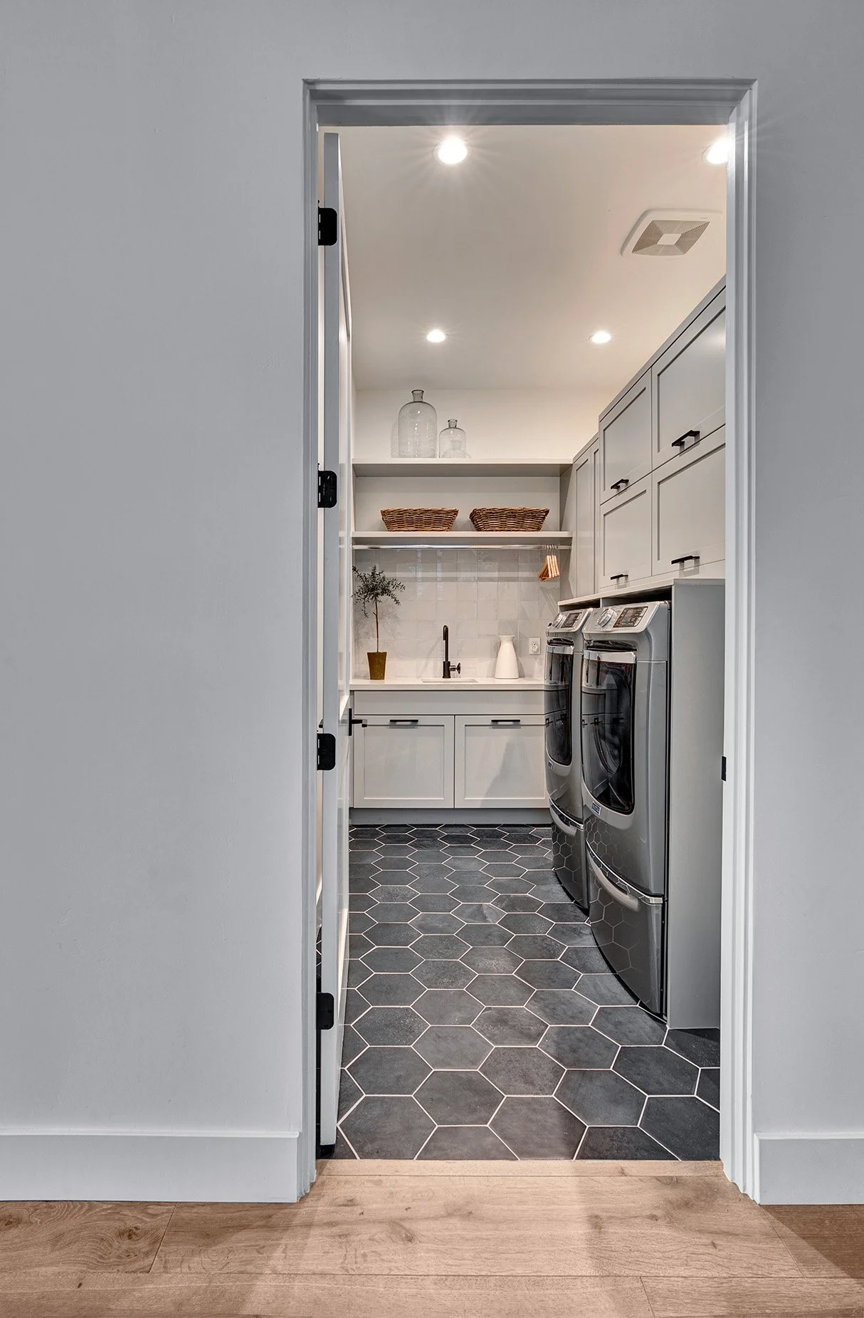 Warm modern new construction home, slim shaker cabinet doors, laundry room