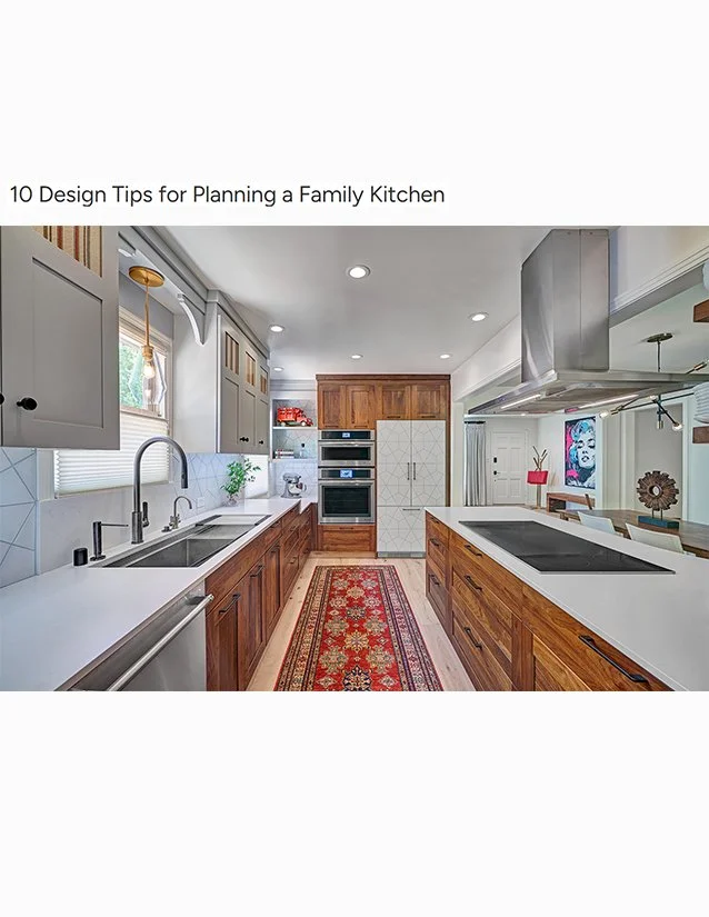 Modern kitchen with gray upper cabinets, wooden lower cabinets, white countertops, stainless steel appliances, a red patterned rug, and a colorful wall art in the dining area.