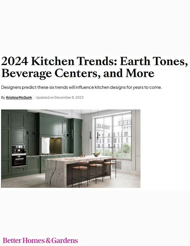 A modern kitchen with green cabinets, a marble island with stools, and large window overlooking city buildings.