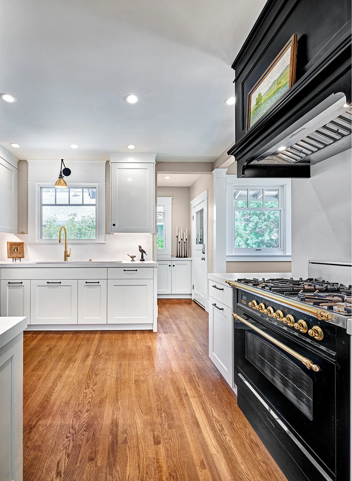 Transitional black + white kitchen remodel, The Galley workstation, cabinet hutch, black range 