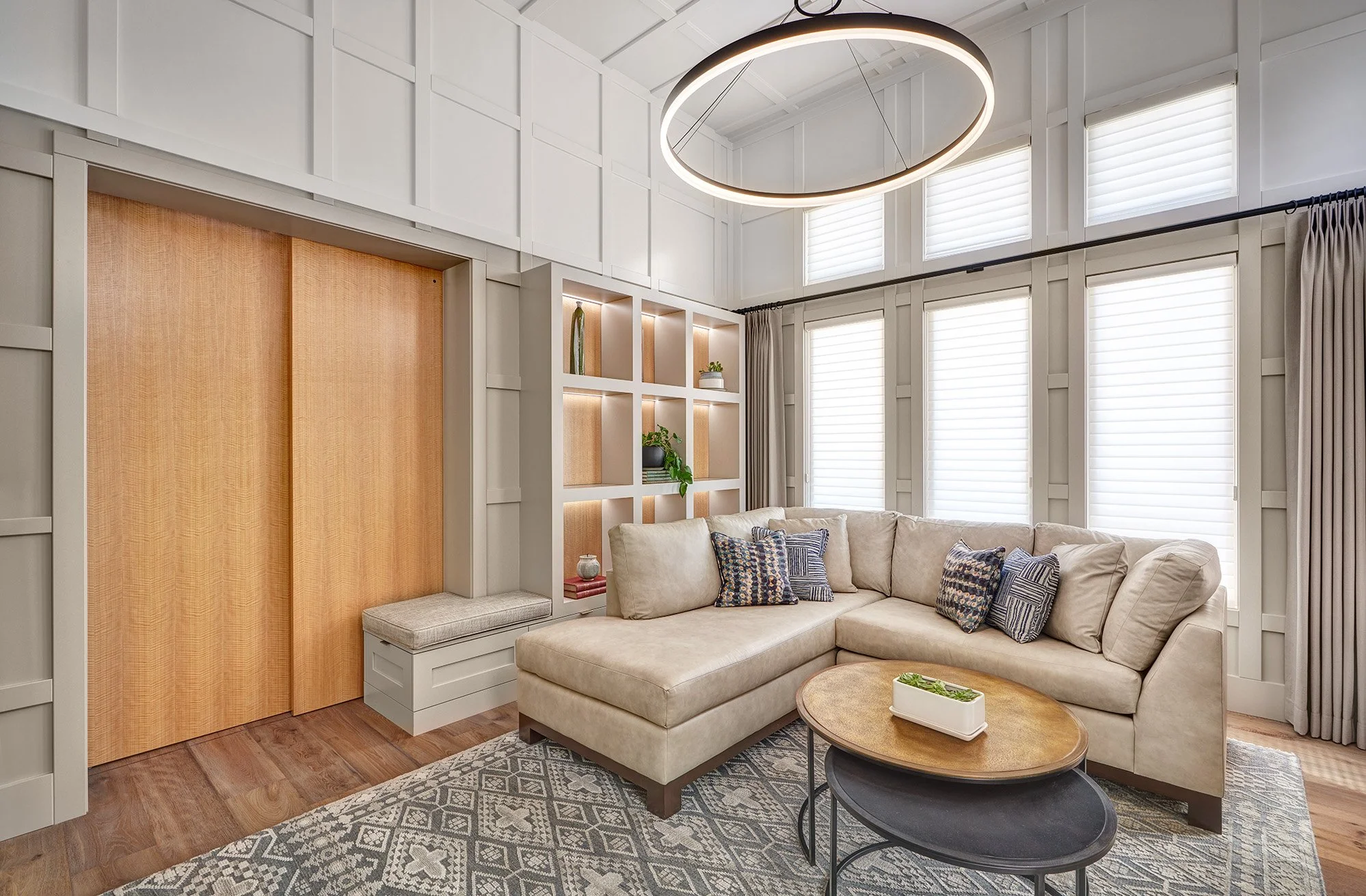 Millwork wrapped living room, linear fireplace, bookshelves, two toned