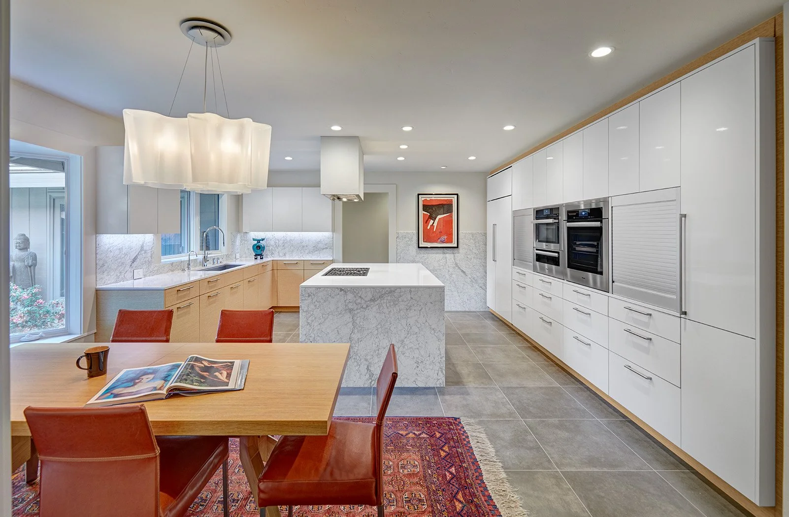 Modern kitchen remodel, wood wrapped white tall cabinet wall, appliance garage, stone waterfall island, workstation sink