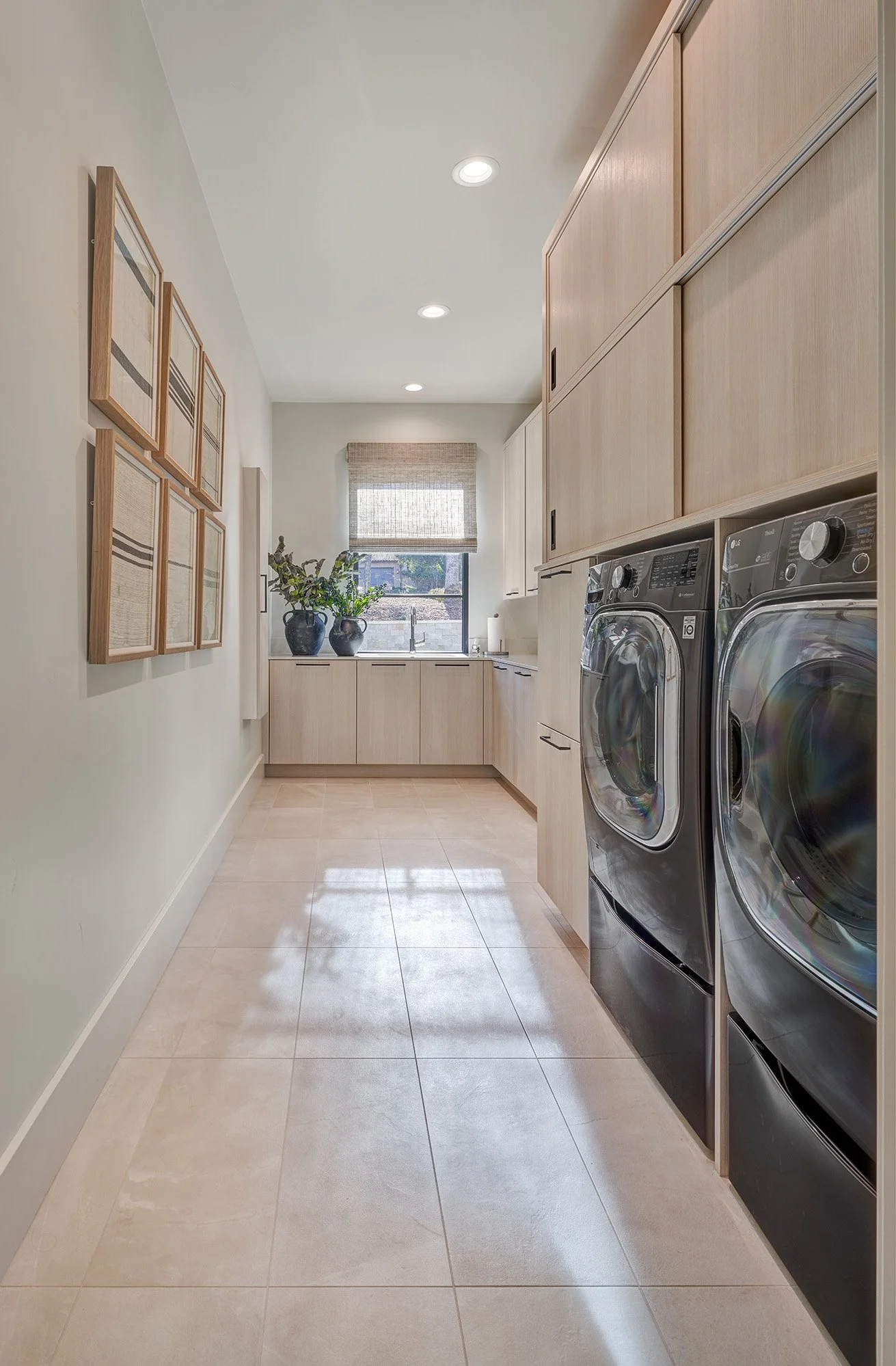 Modern new construction home, European cabinetry, sliding cabinet doors, laundry room