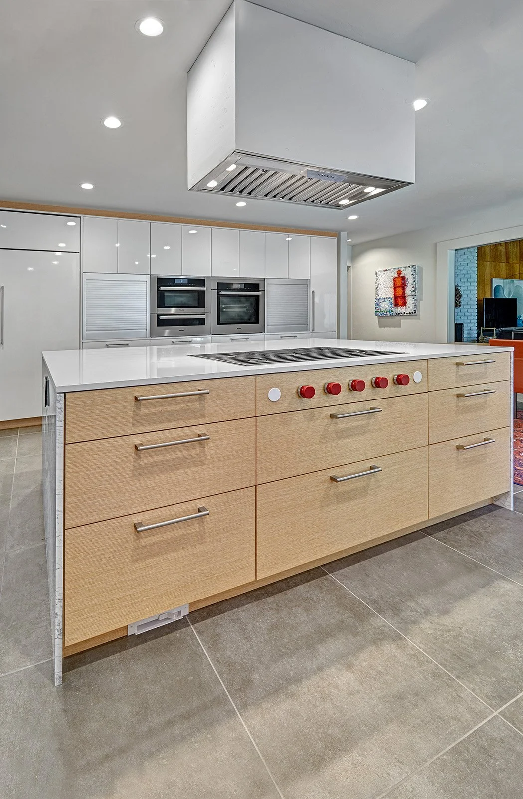 Modern kitchen remodel, wood wrapped white tall cabinet wall, appliance garage, stone waterfall island, flush cooktop