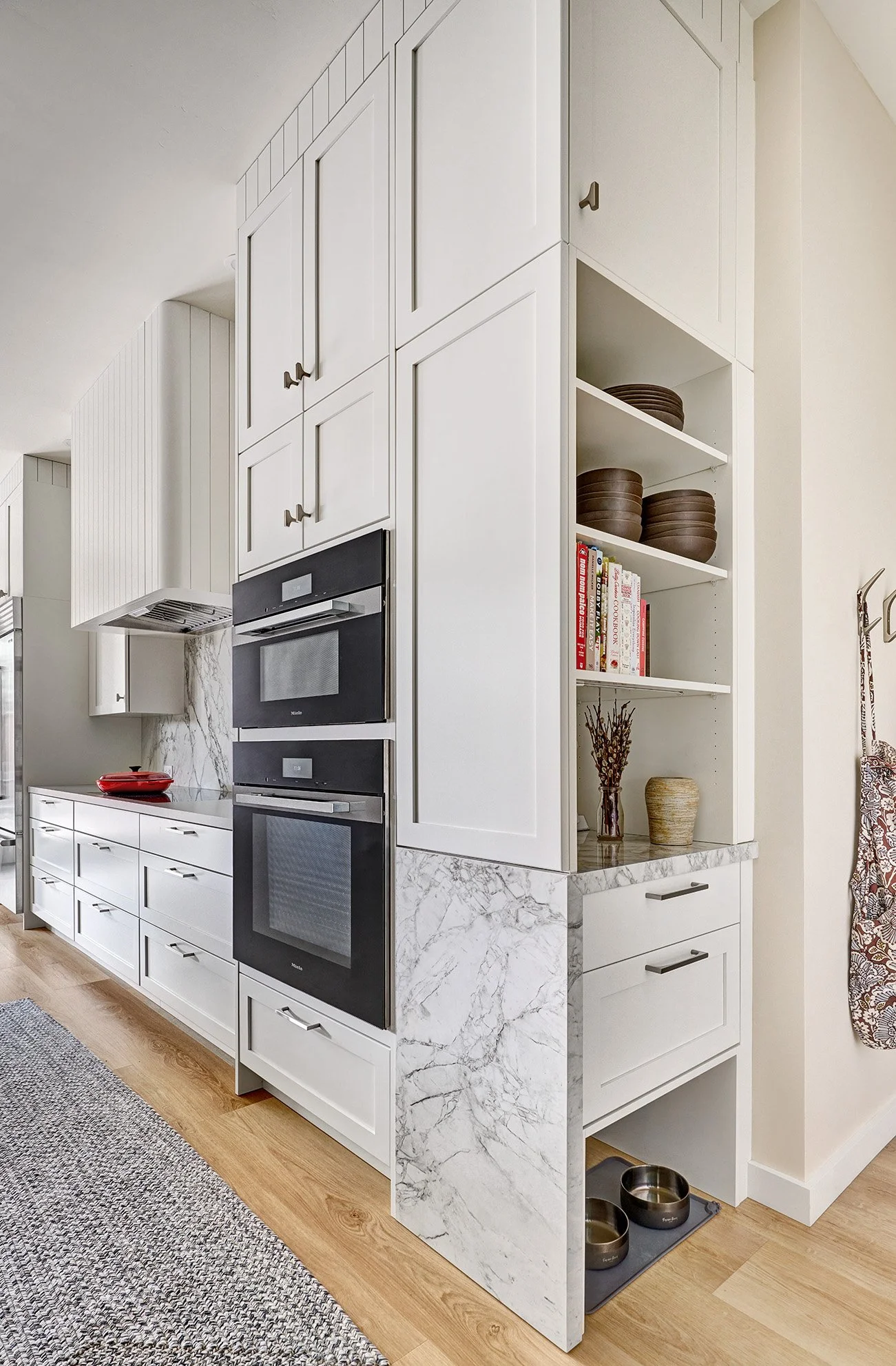 Kitchen with white, wood and green cabinetry. Landing zone with charging and dog station.
