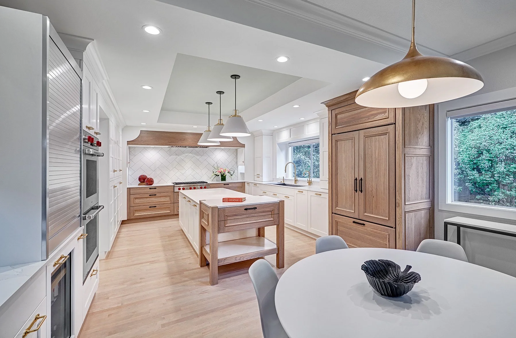 Home remodel, warm contemporary kitchen, hickory and white cabinetry, Sub-Zero Wolf appliances, open legwork island endcap