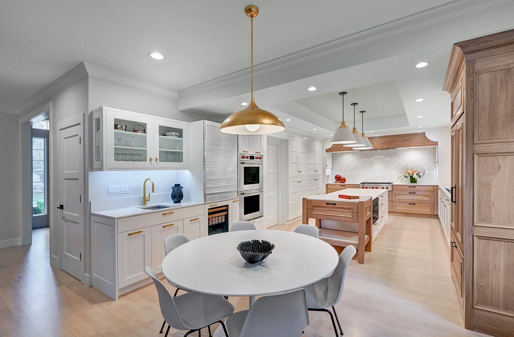 Home remodel, warm contemporary kitchen, hickory and white cabinetry, Sub-Zero Wolf appliances, open legwork island endcap, beverage center, appliance garage