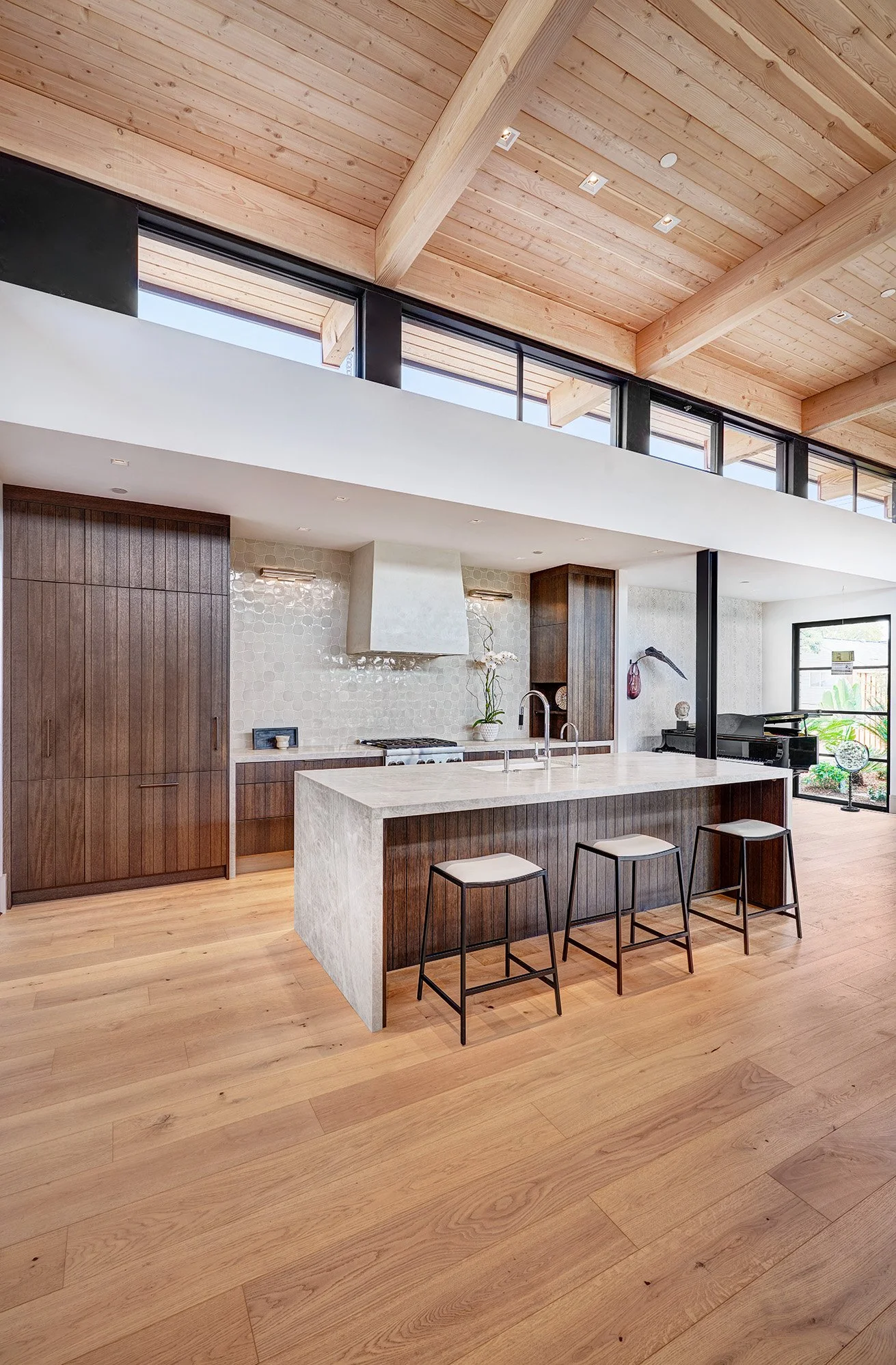 Warm contemporary new construction home, kerf cut kitchen cabinet, waterfall stone island, paneled appliances
