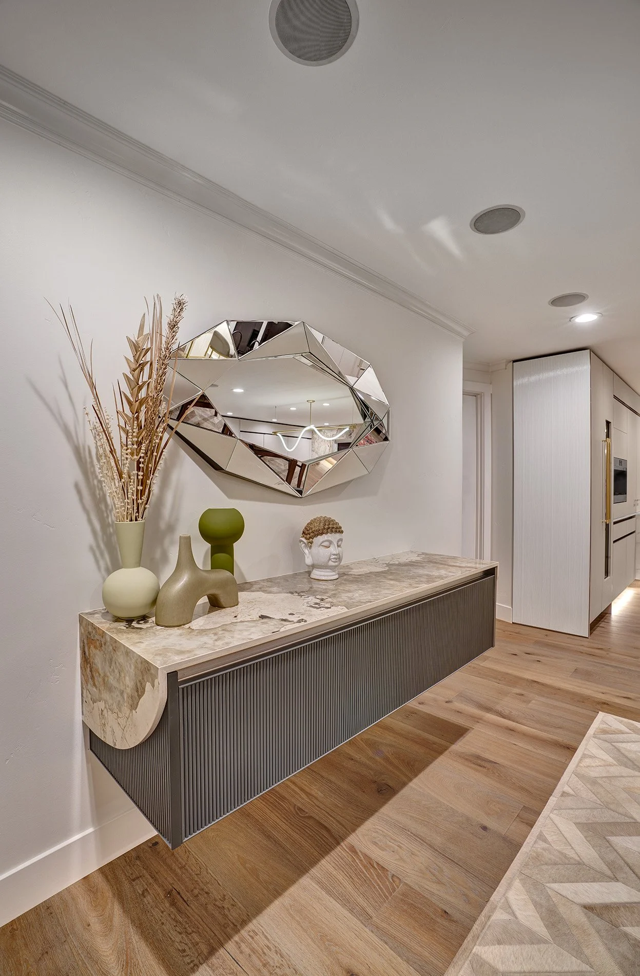 Modern dining room, floating custom ribbed cabinetry, swooped Dekton surface
