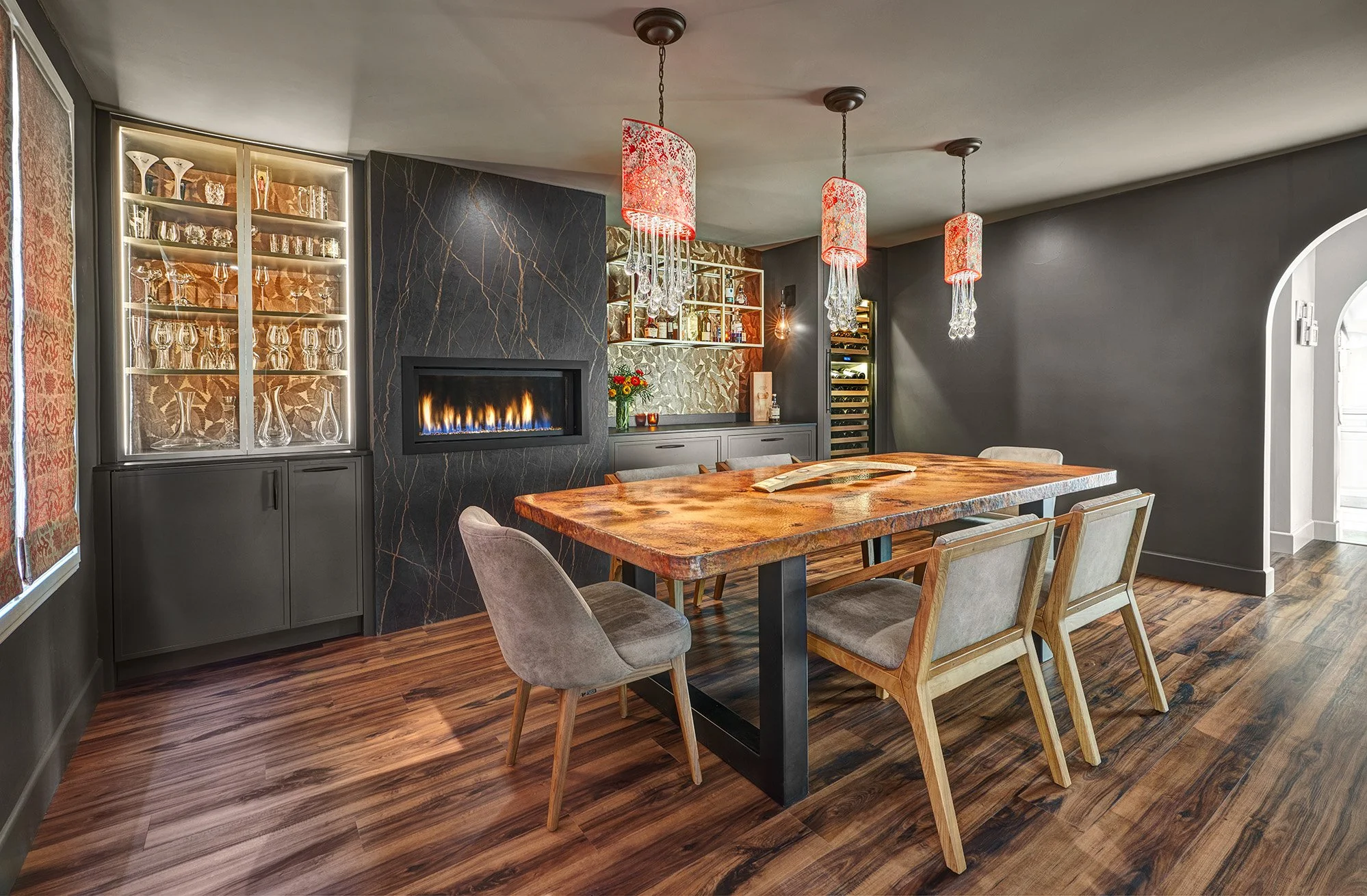 Remodeled dining room, European cabinetry, glass front internally lit display cabinet, paneled wine refrigerator, linear fireplace