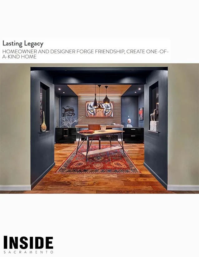 Interior view of a modern home office with dark walls, wooden flooring, and eclectic artwork, including a large tiger face painting, from the INSIDE Sacramento publication.