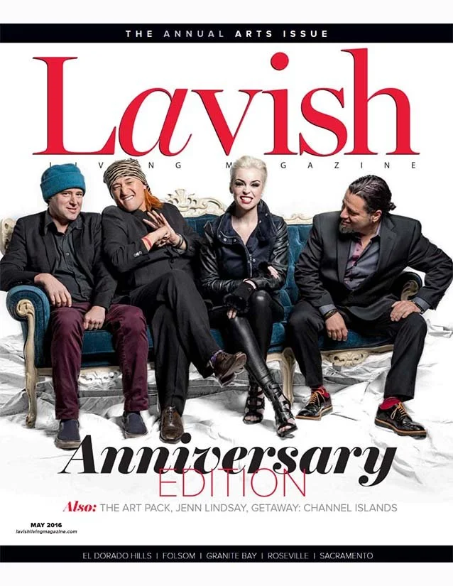 Cover of Lavish magazine's anniversary edition featuring four people sitting on a vintage-style sofa, smiling and posing for the camera, with the magazine title prominently displayed at the top.