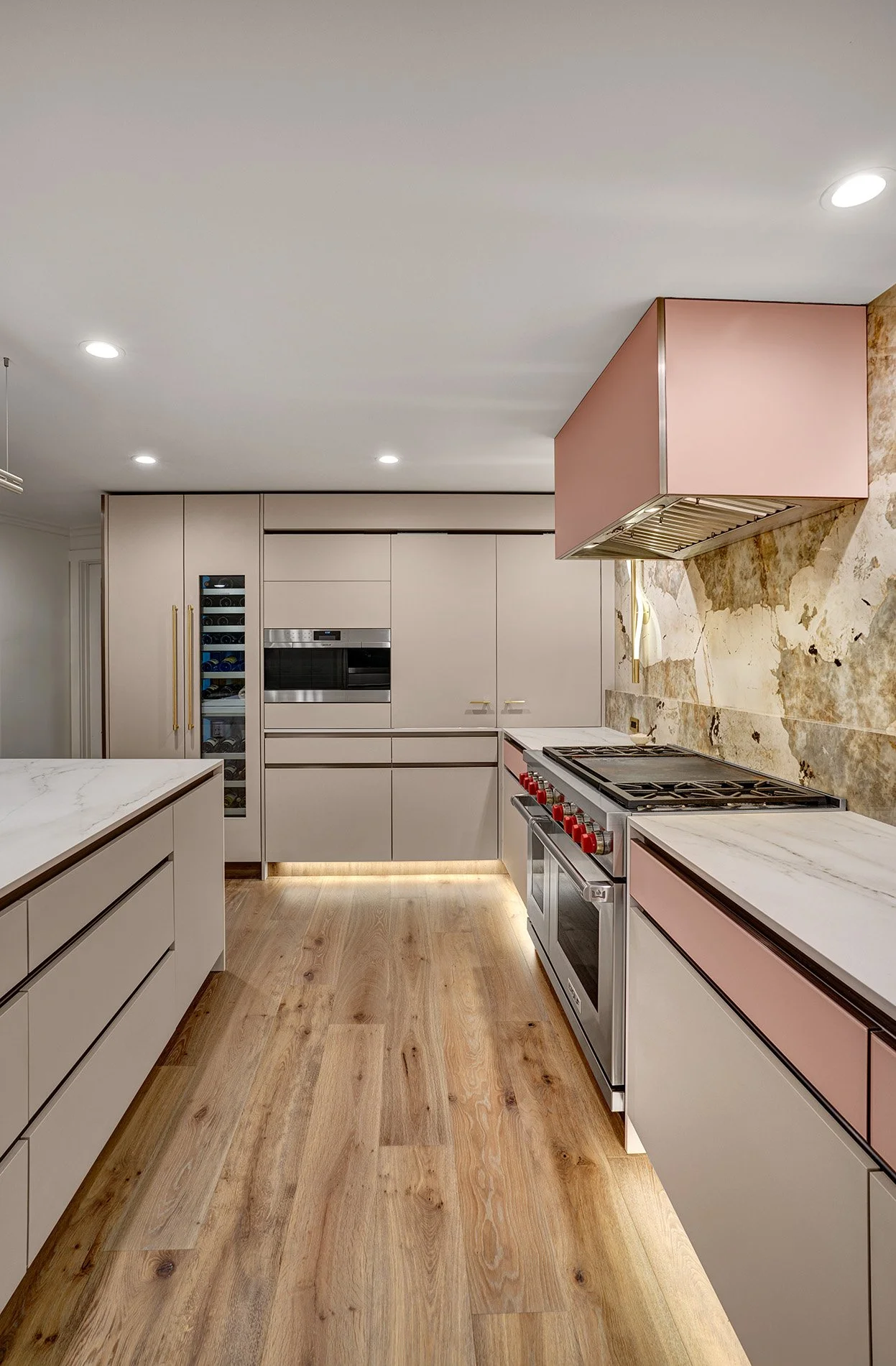 Modern kitchen remodel, blush glass drawer fronts, channel hardware, coplanar cabinet doors, wine refrigerator