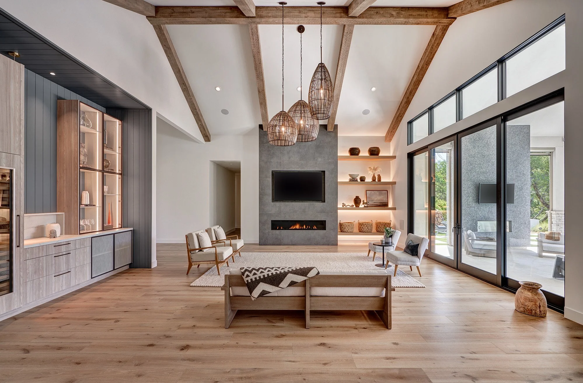 Warm modern new construction home, linear fireplace, wood beams, backlit cabinet shelving