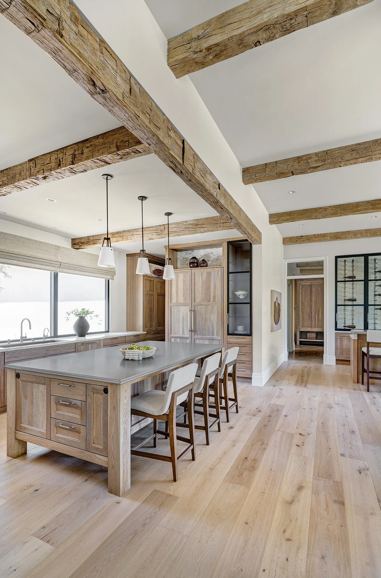 French Villa style hickory cabinetry, large metal finish island top, rustic beams, glass front cabinetry, Galley Workstation, Wolf Range