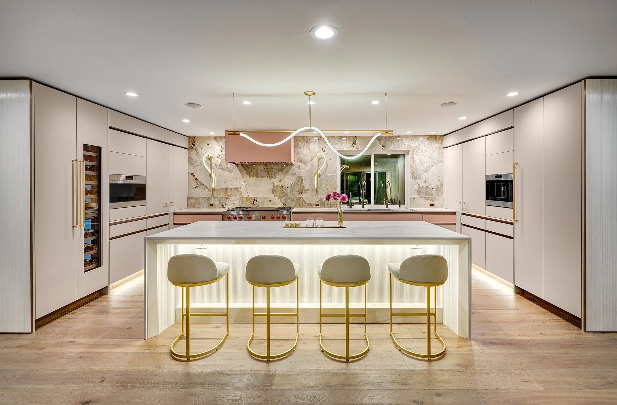 Modern kitchen remodel, blush glass drawer fronts and hood, custom ribbed paneling, European cabinetry, The Galley workstation