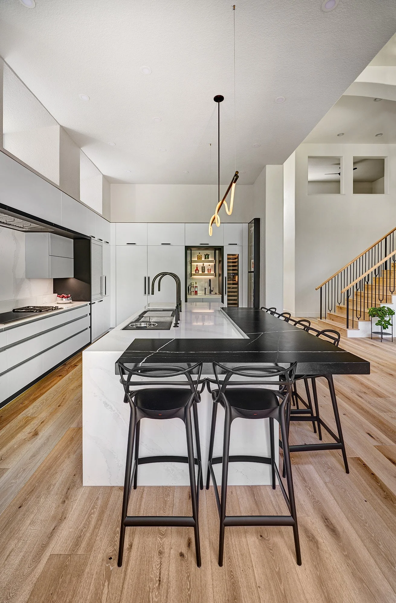 Modern kitchen remodel, black + white, large island, European cabinetry, Luke Lamp Co. chandelier