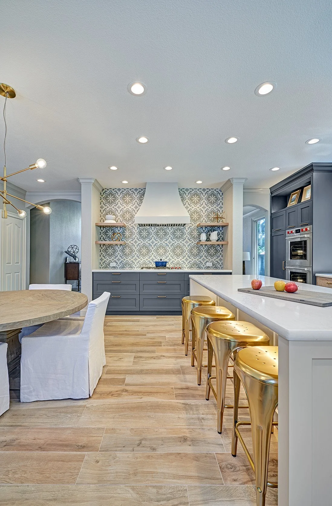 Modern Spanish colonial style kitchen remodel, blue, white + wood cabinetry, large seating island, patterned tile splash
