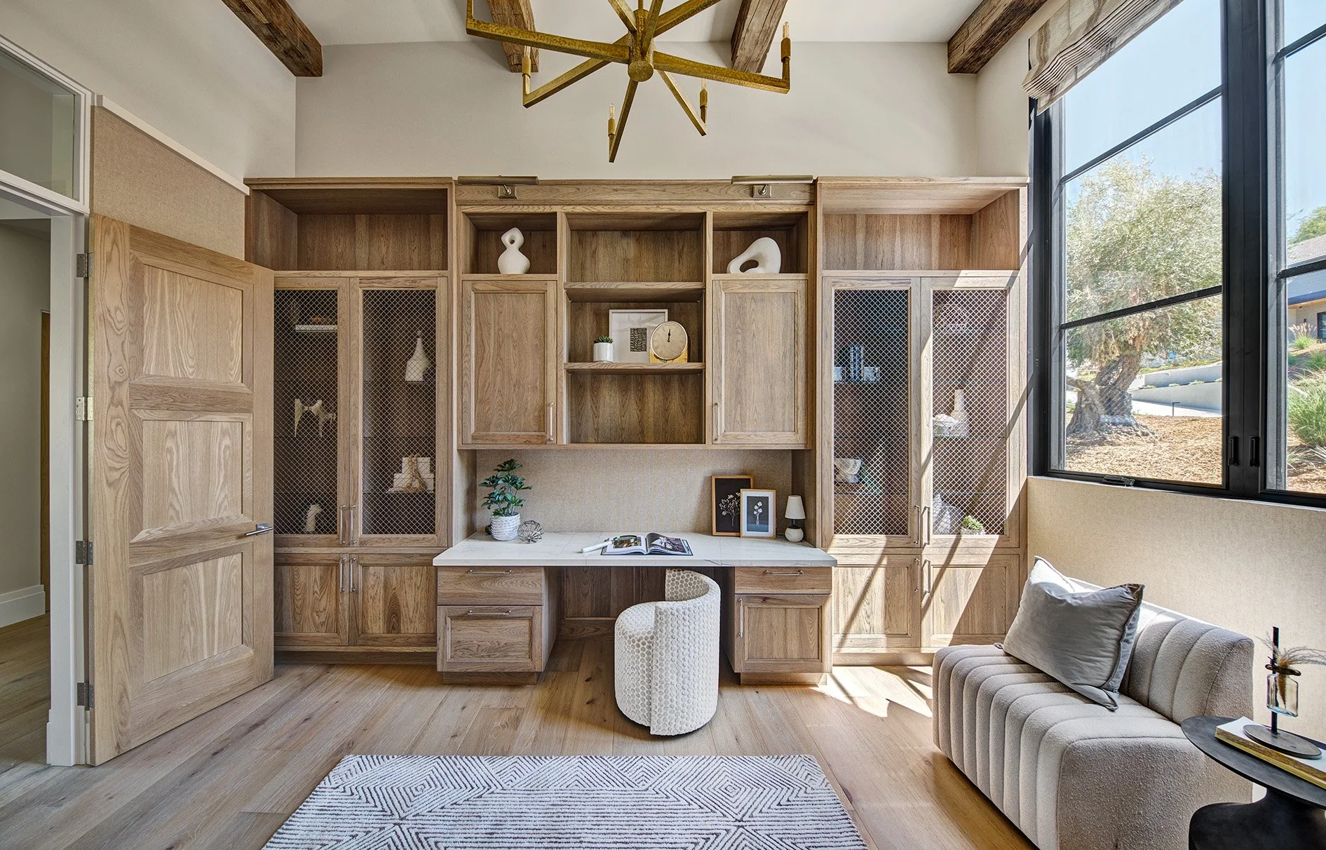Warm hickory office cabinetry, metal mesh doors, custom desk