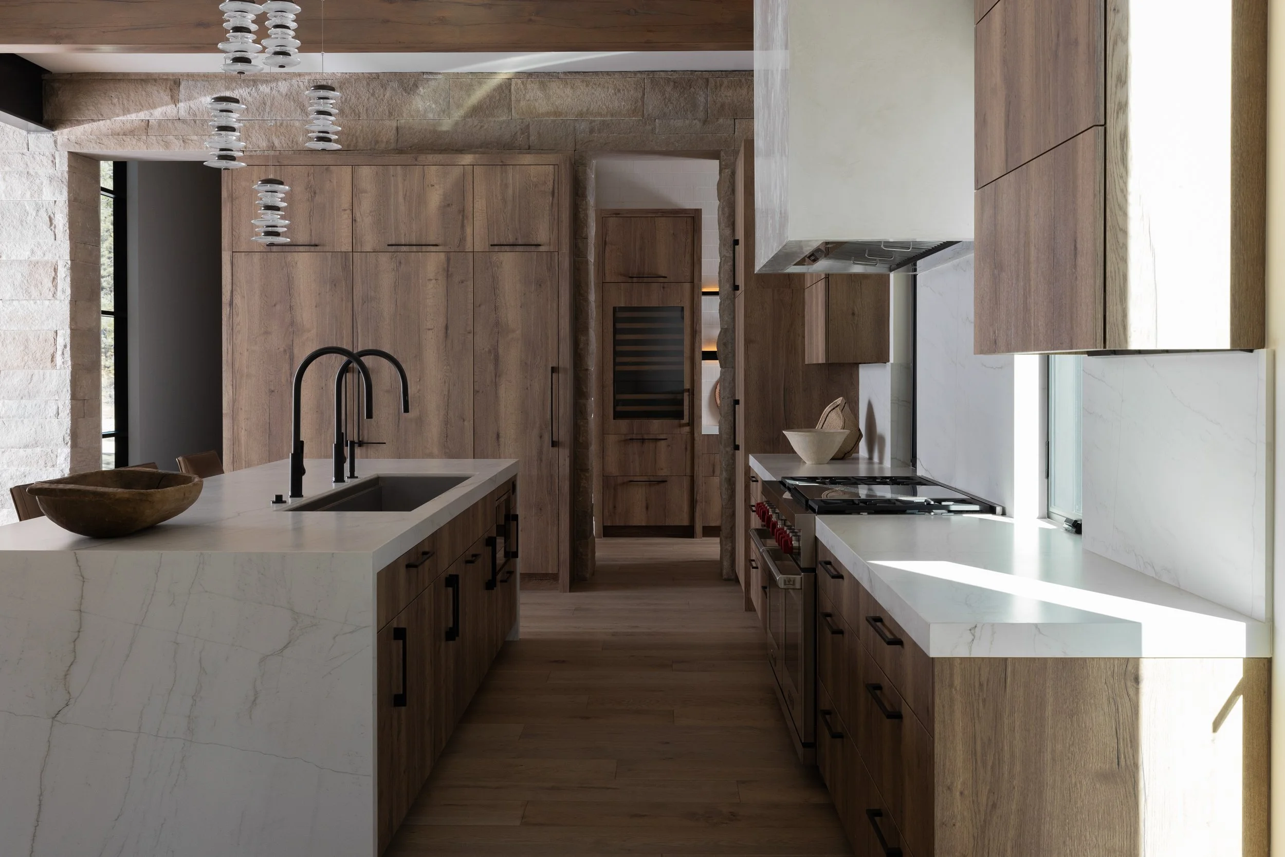 Mountain modern rustic kitchen, warm laminate cabinetry, stone splash