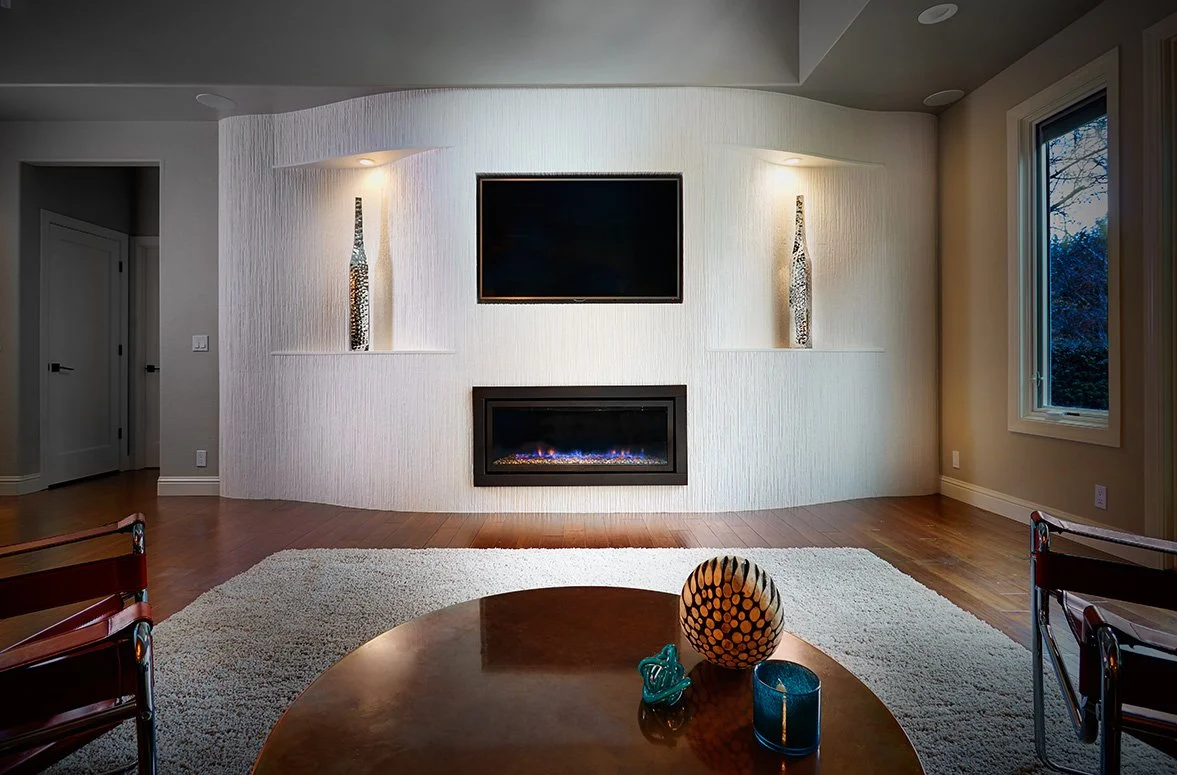 Fireplace wall with curves, tiled, inset TV, art display niches