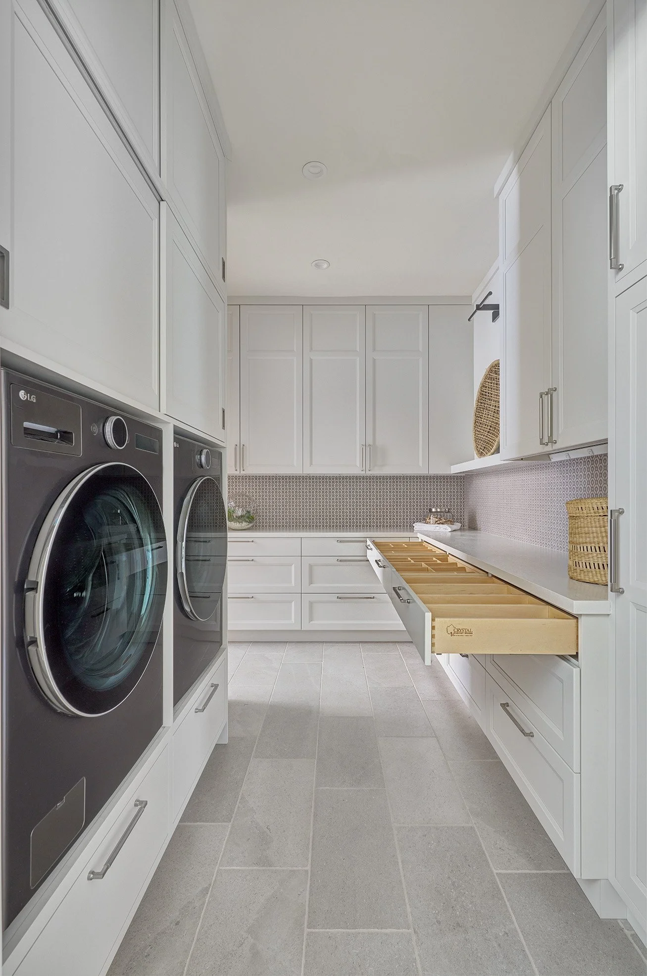 White, shaker style cabinetry, laundry room, clean, drawer inserts
