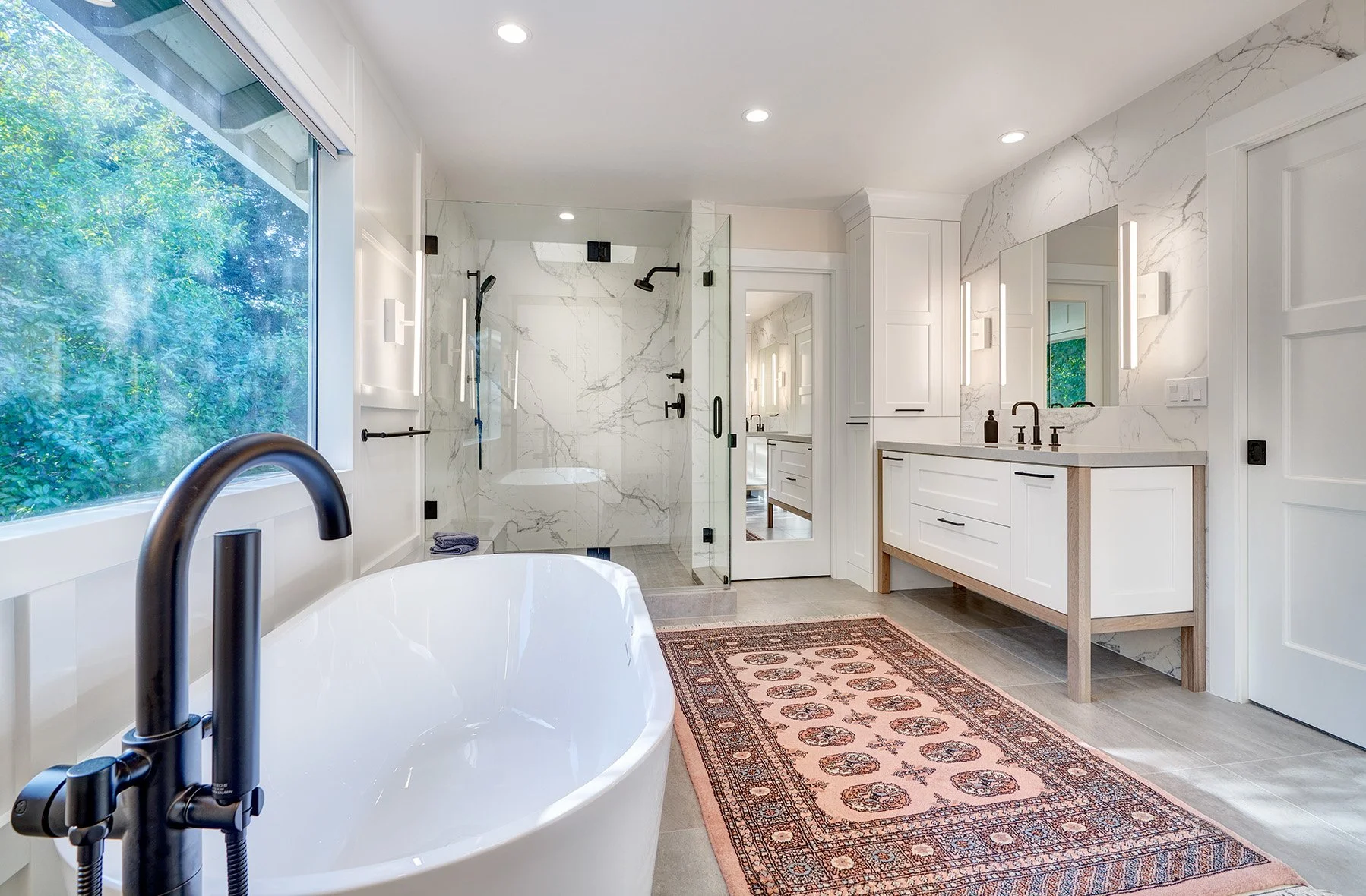 Home remodel, primary bathroom, open wood leg cabinet vanity, stone splash, freestanding tub