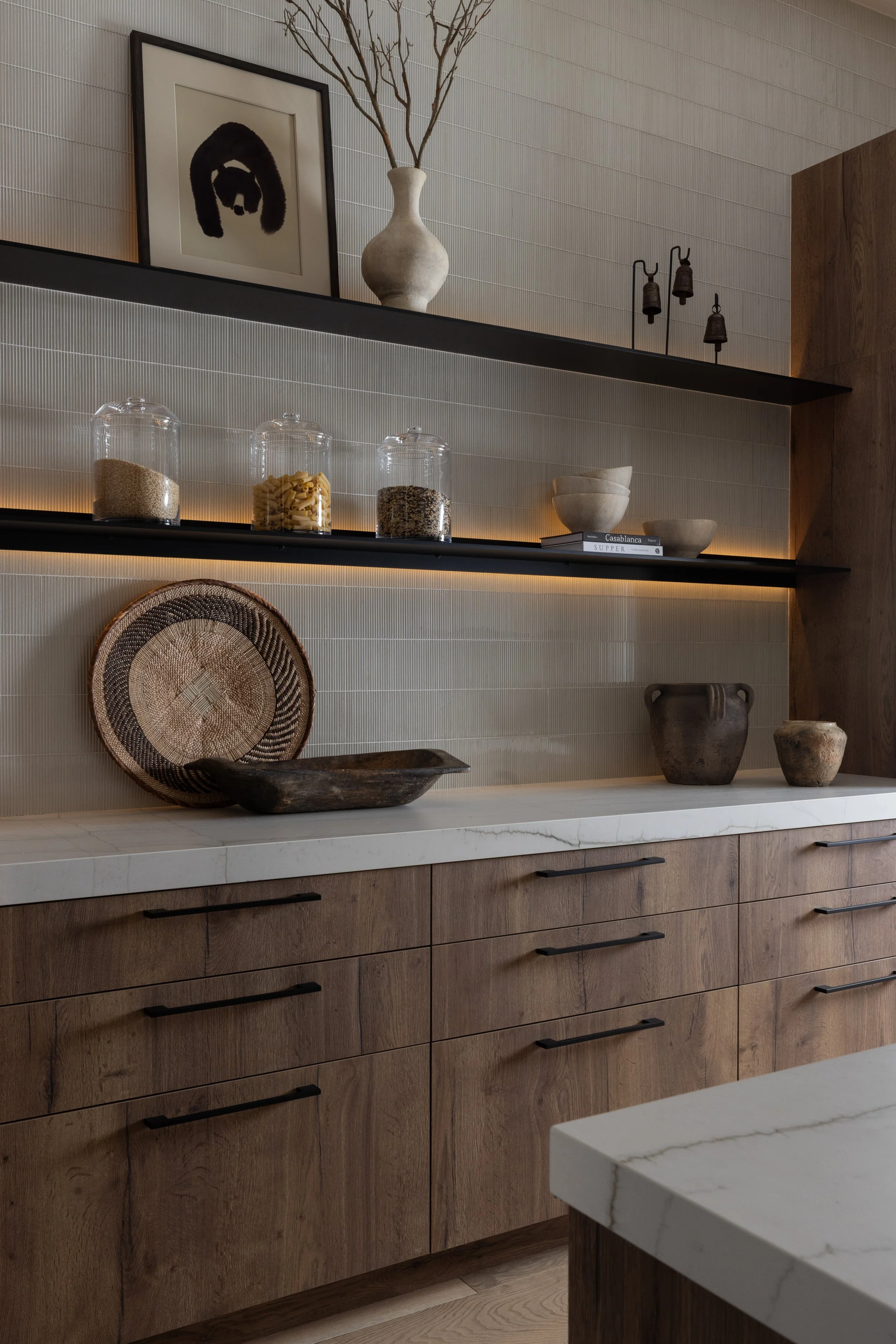 Warm rustic modern butler/pantry, lit floating shelves, warm wood laminate cabinetry