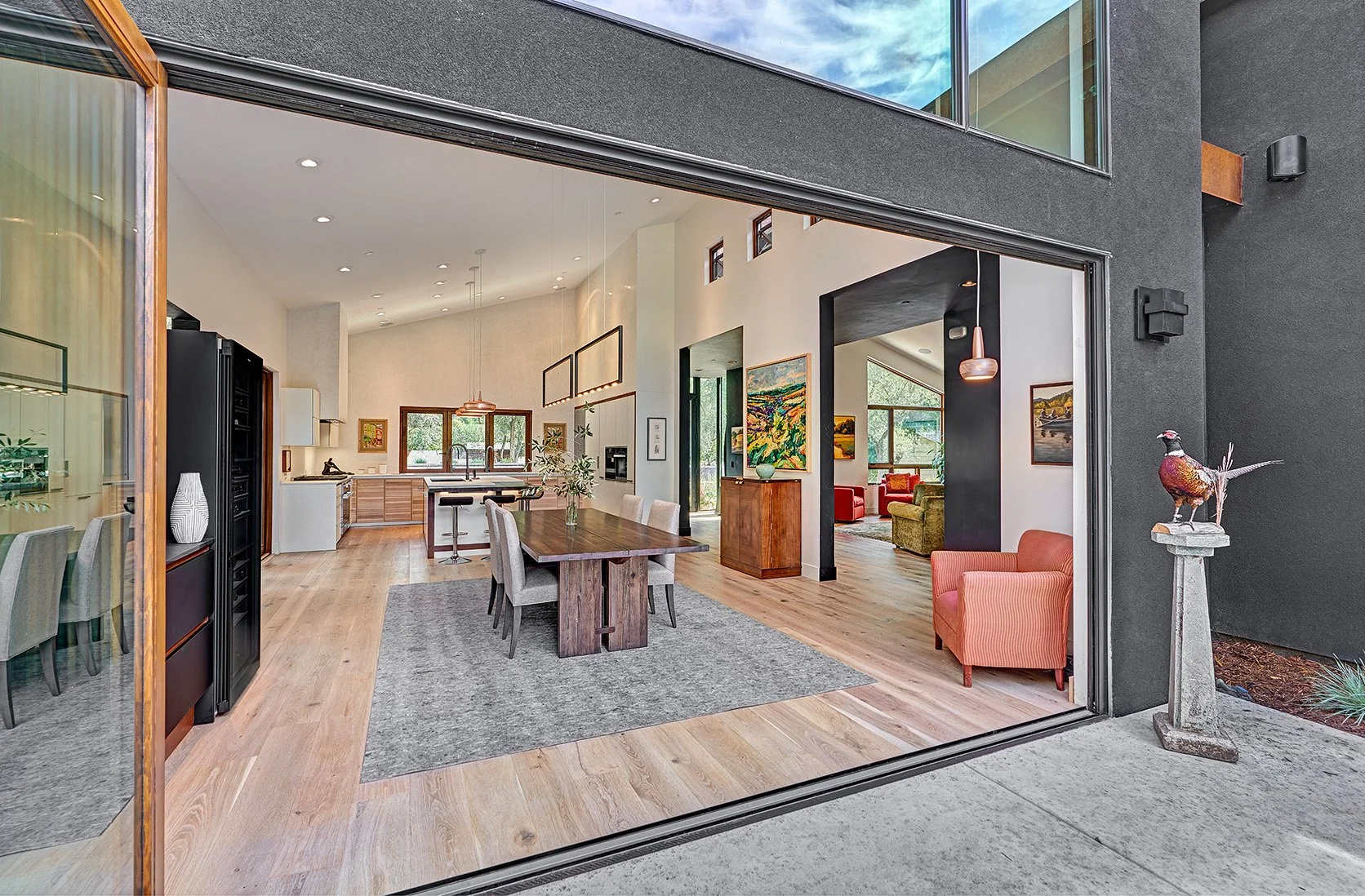 Modern home remodel, large accordion stacking glass doors, dining room and kitchen