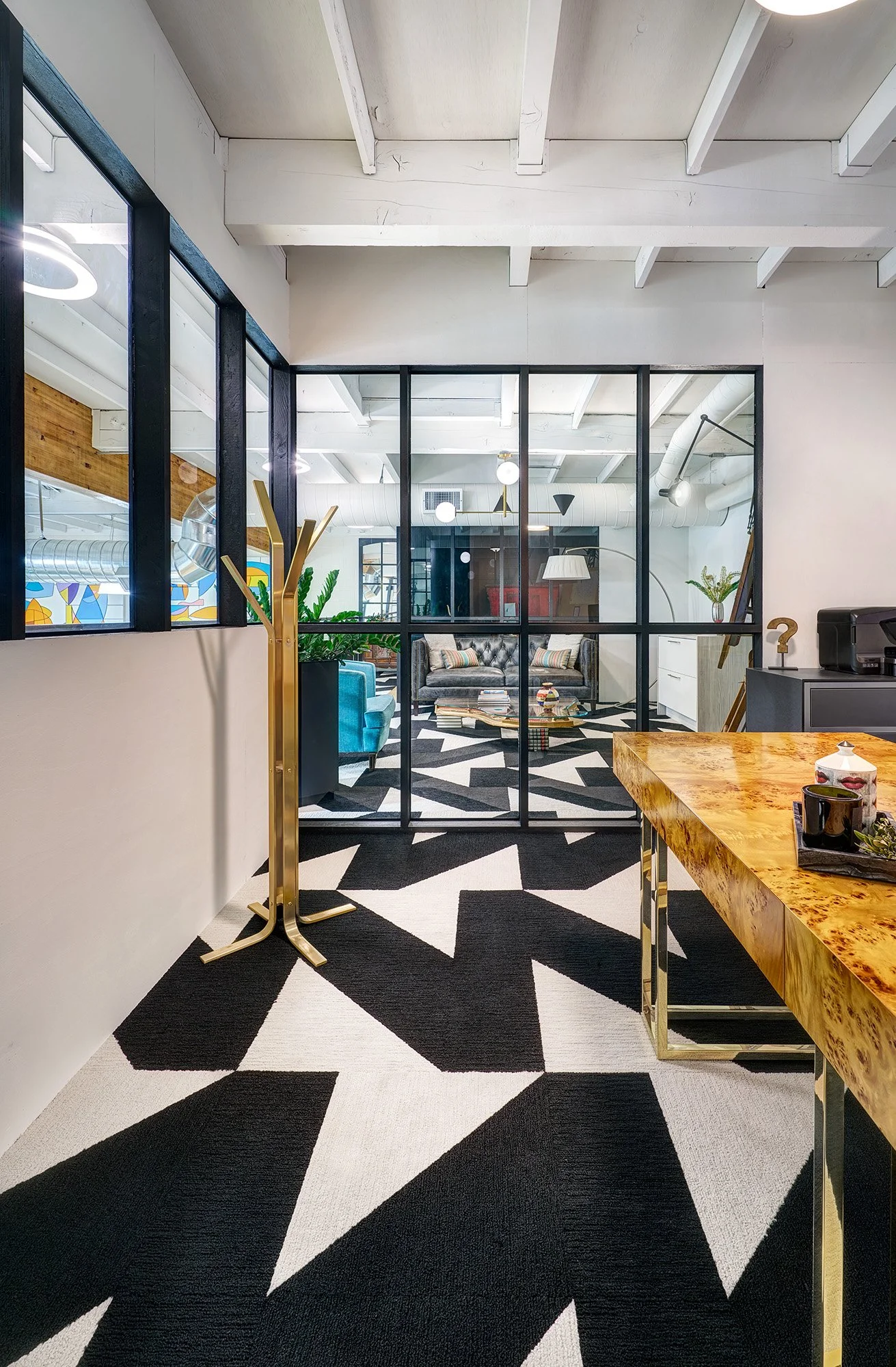 Mezzanine of interior design firm, black and white carpet, glass wall office