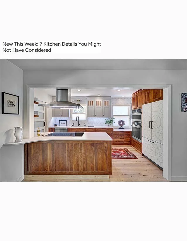Modern kitchen with white and wooden cabinets, a kitchen island, stainless steel appliances, and a small window with a decorative rug on the floor.