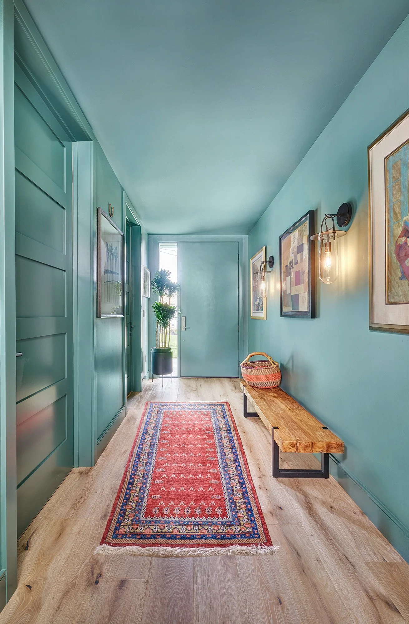 New construction ADU home, teal entry, sconces, art