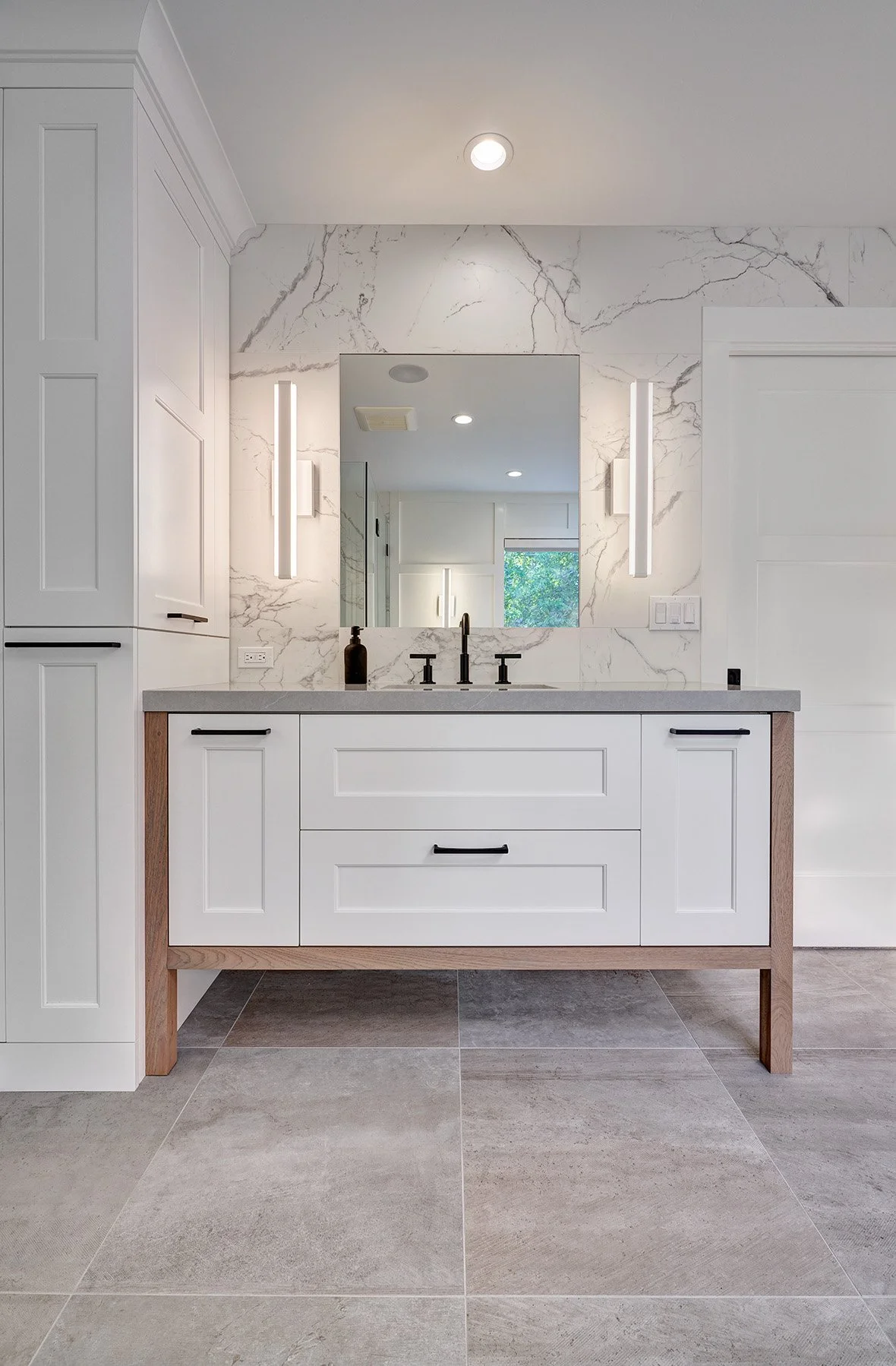 Home remodel, primary bathroom, open wood leg cabinet vanity, stone splash