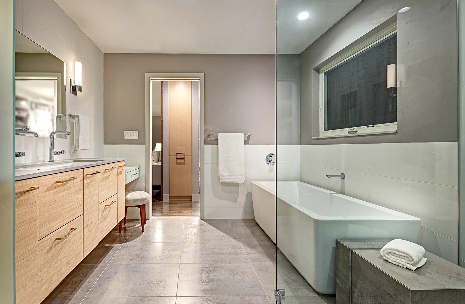 Modern primary bath remodel, laminate cabinetry, glass shower and toilet enclosures, freestanding tub