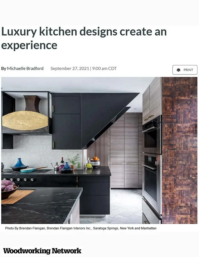 Modern black kitchen with a marble countertop, built-in ovens, and wood cabinetry, featuring dark walls and a unique angled ceiling design.