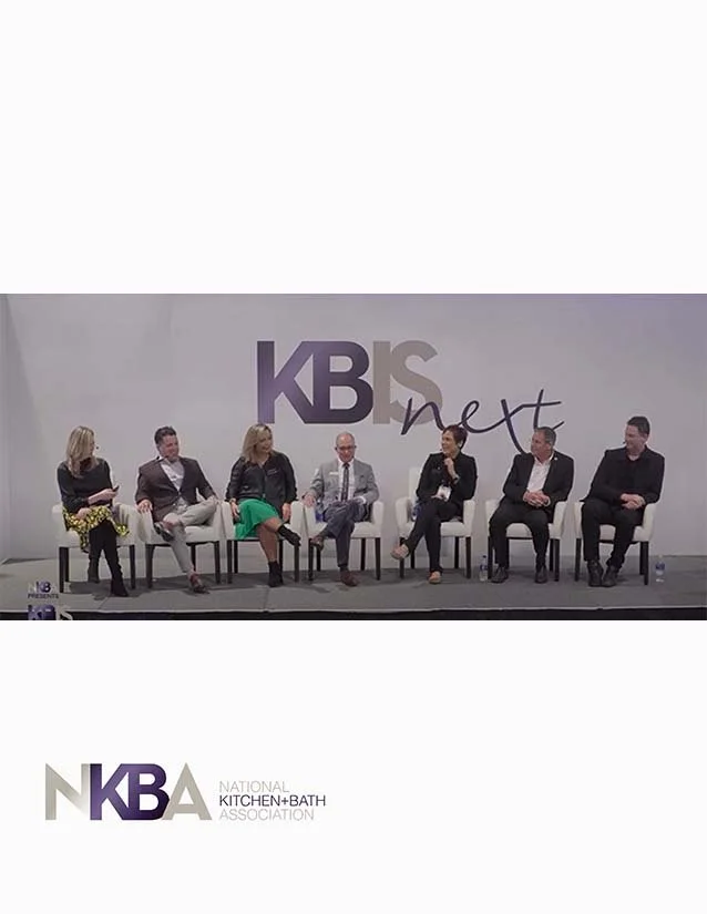 A panel of seven people sitting on stage at a National Kitchen and Bath Association event, with a large KBS and NKBA logo in the background.