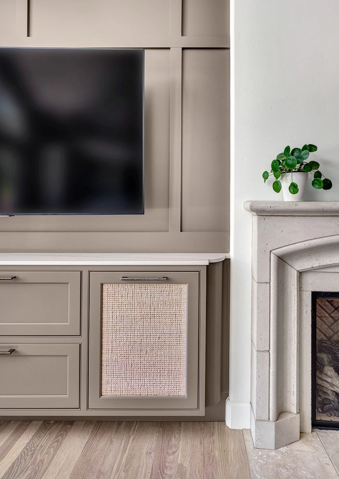 Warm taupe cabinetry media center, millwork detail behind wall mounted TV, woven media screen