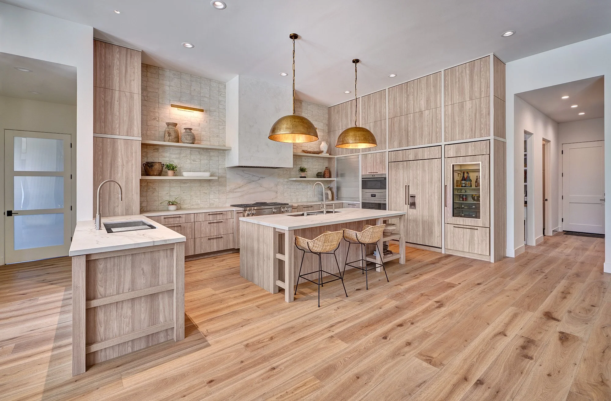 Warm modern new construction home, kitchen, European laminate cabinetry, The Galley workstation, Sub-Zero + Wolf appliances