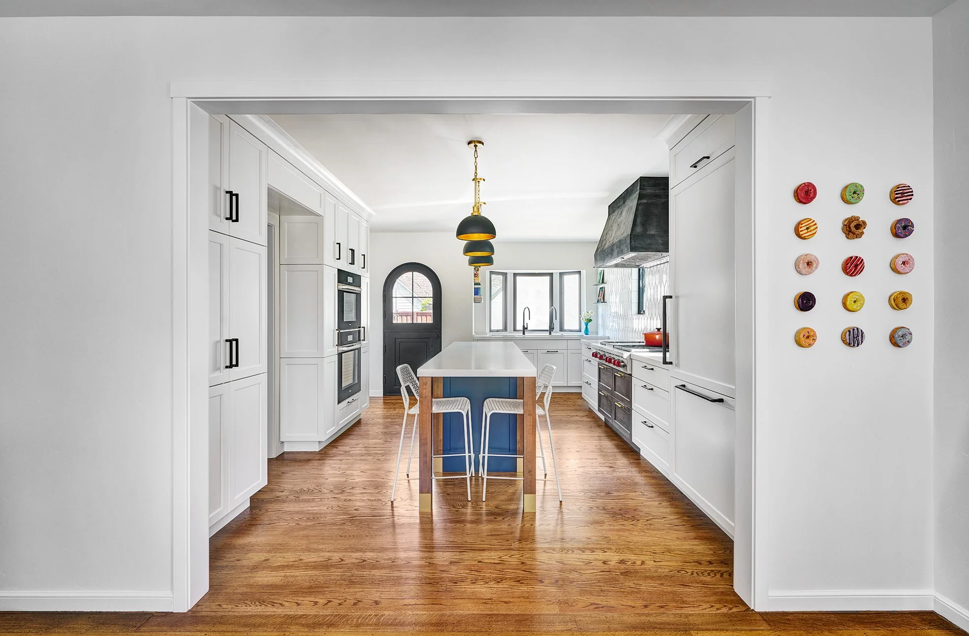 1930s kitchen remodel, white, blue + wood cabinetry, seating island, paneled refrigerator