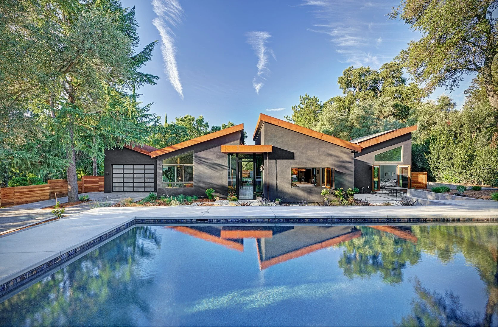 Whole home remodel, exterior view, pool, angled roofs