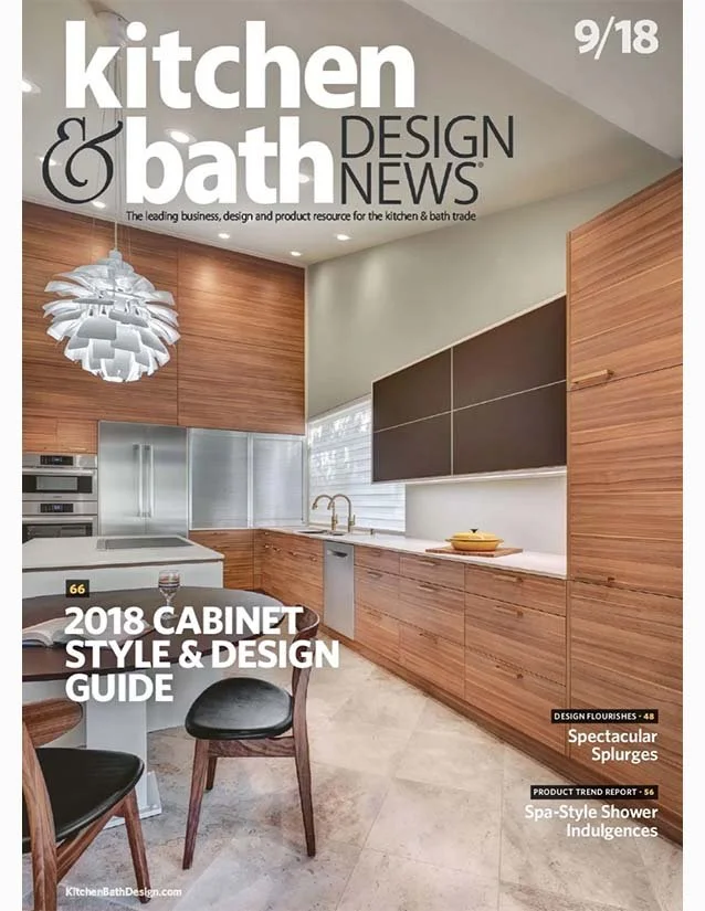 Magazine cover of 'kitchen & bath design news' featuring a modern kitchen with wooden cabinets, a white countertop, and a window with blinds. Includes headlines about cabinet style guide, design flourishes, and spa-style shower trends.