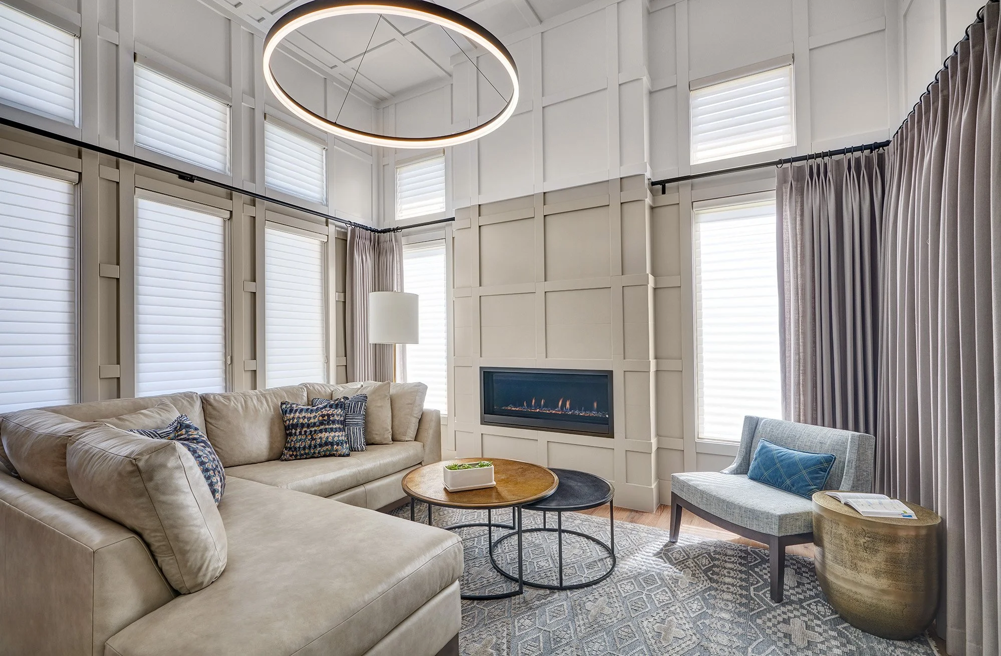 Millwork wrapped living room, linear fireplace, bookshelves, two toned